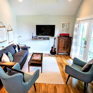 Living room with natural lighting from french doors that lead to a deck.