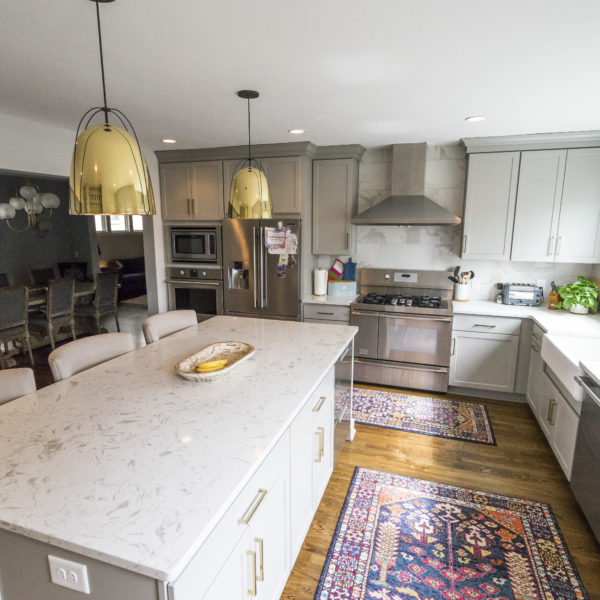 kitchen remodel with gray cabinets and marble backsplash