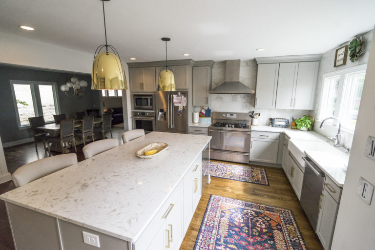 kitchen remodel with gray cabinets and marble backsplash