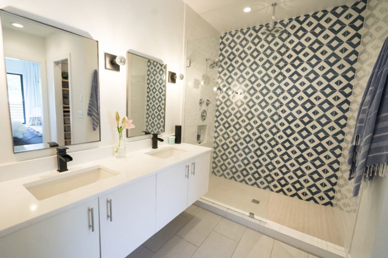 bathroom remodel with white and blue backsplash