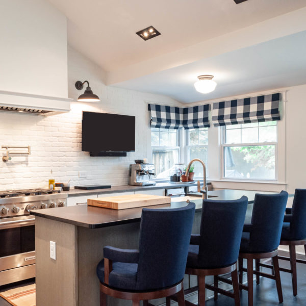 blue and white kitchen renovation with white brick wall