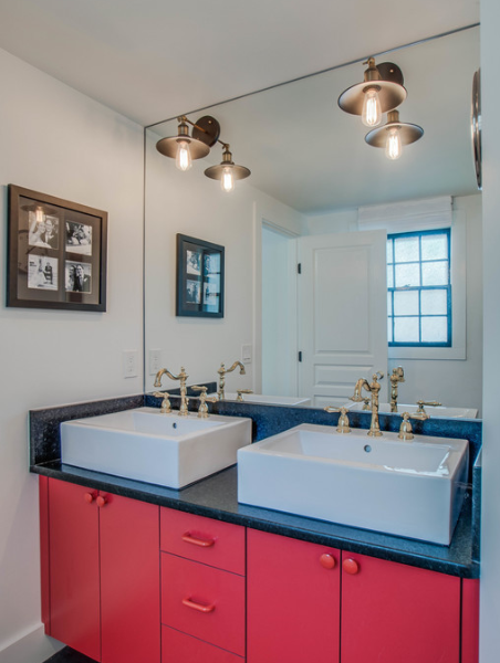 Bathroom with red cabinets and gold sink handles