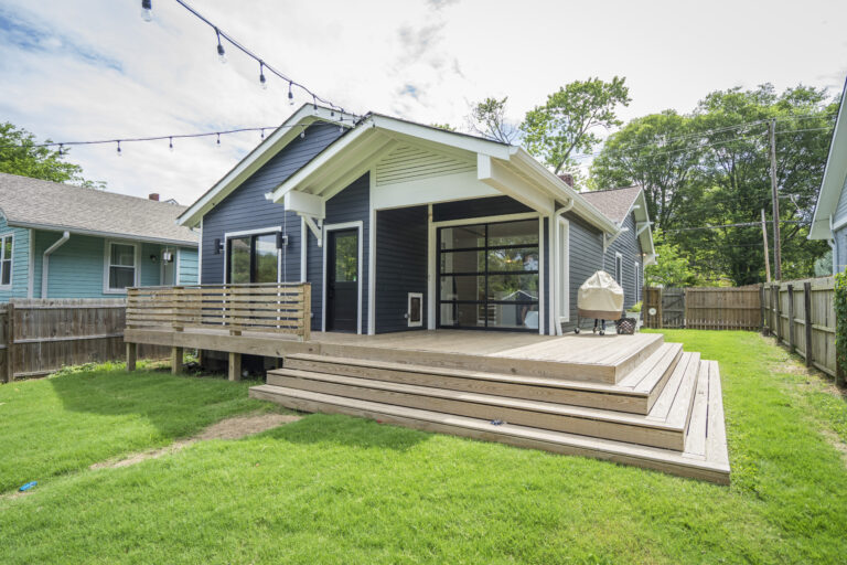 elevated deck in front of blue house
