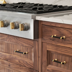 An upclose shot of a gas stove remodel. Around the stove are the multiple drawers on the new custom cabinets.