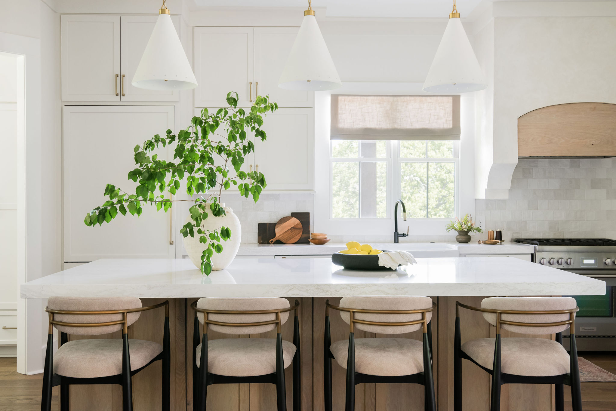 kitchen remodel completed by nashville general contractor the dan company. natural light, contemporary interior design, marble countertops, kitchen island, and range hood.