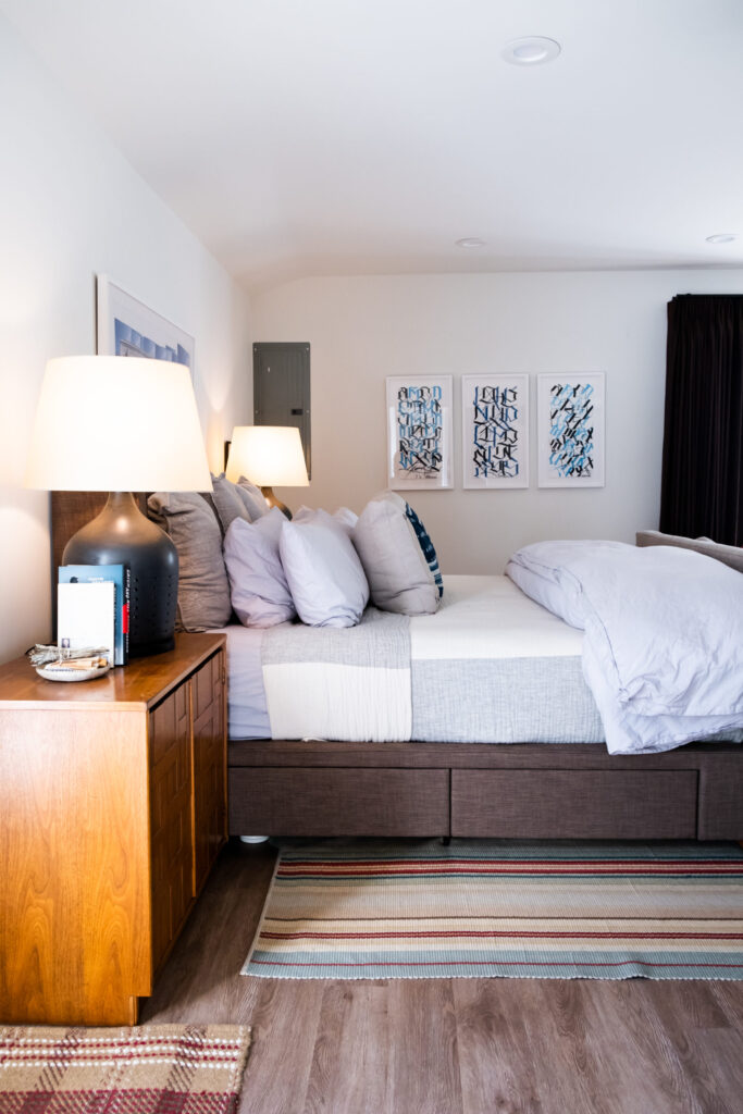 Comfortable bedroom with large bed and warm lighting accents.