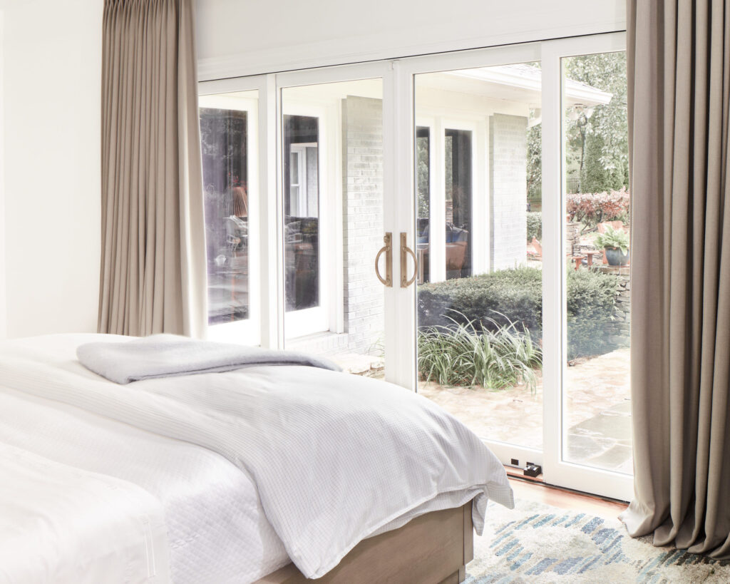 Bright bedroom with sliding glass doors leading to an outdoor patio.