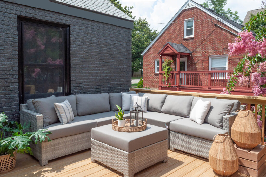 Stylish outdoor deck with sectional seating and decorative furnitures.