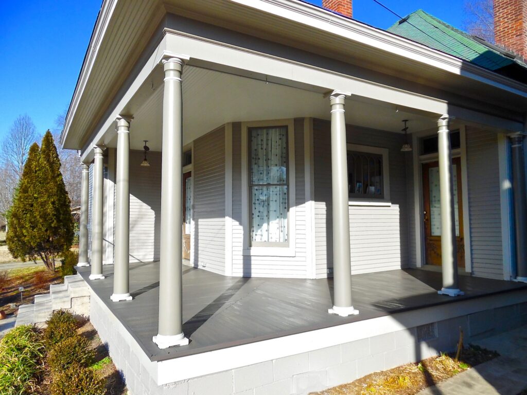 Classic front porch featuring tall columns and wrap-around space.