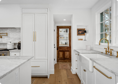 Compact kitchen remodel with a sleek white marble island and modern fixtures.