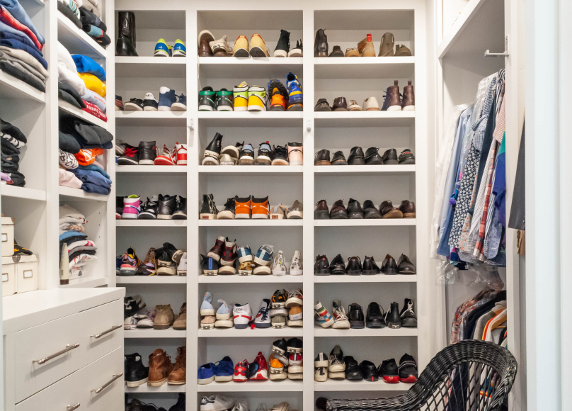 Spacious walk-in closet with built-in storage for shoes and clothes.