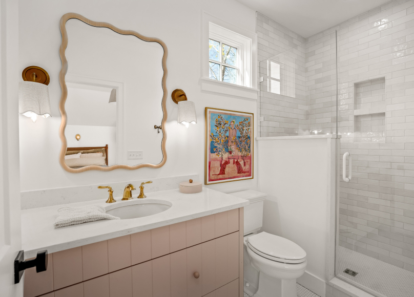 Full bathroom renovation with a modern vanity, walk-in shower, and decorative artwork.