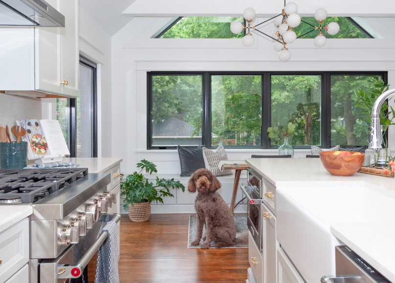 Custom-designed kitchen space with large windows and modern fixtures.