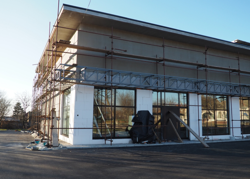 Building under construction with scaffolding on the exterior.
