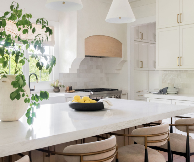 Bright kitchen remodel with large windows, marble island, and custom cabinetry.