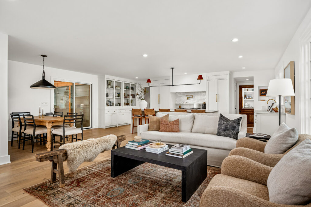 Open-concept living space with a neutral color scheme and dining area.